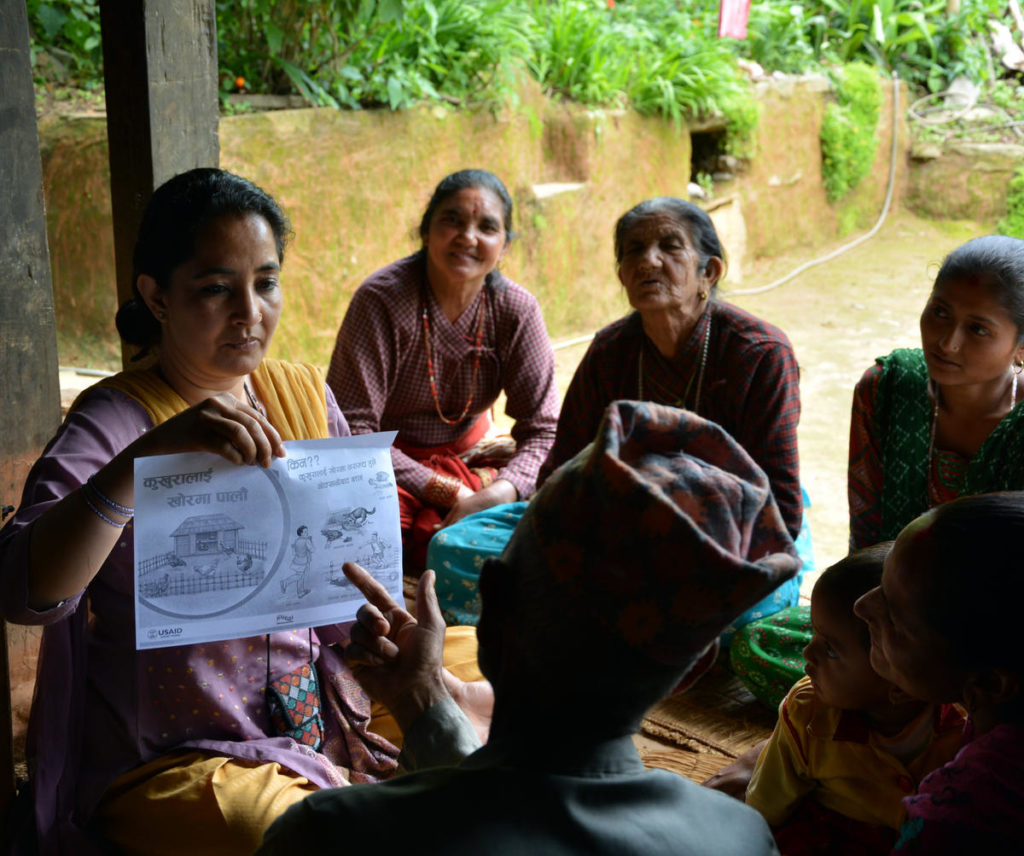 Suaahara staff field test a health communication material about Essential Hygiene Actions (EHA) for agriculture in District of Dolakha, Nepal. © 2013 Valerie Caldas/ Johns Hopkins University Center for Communication Programs, Courtesy of Photoshare